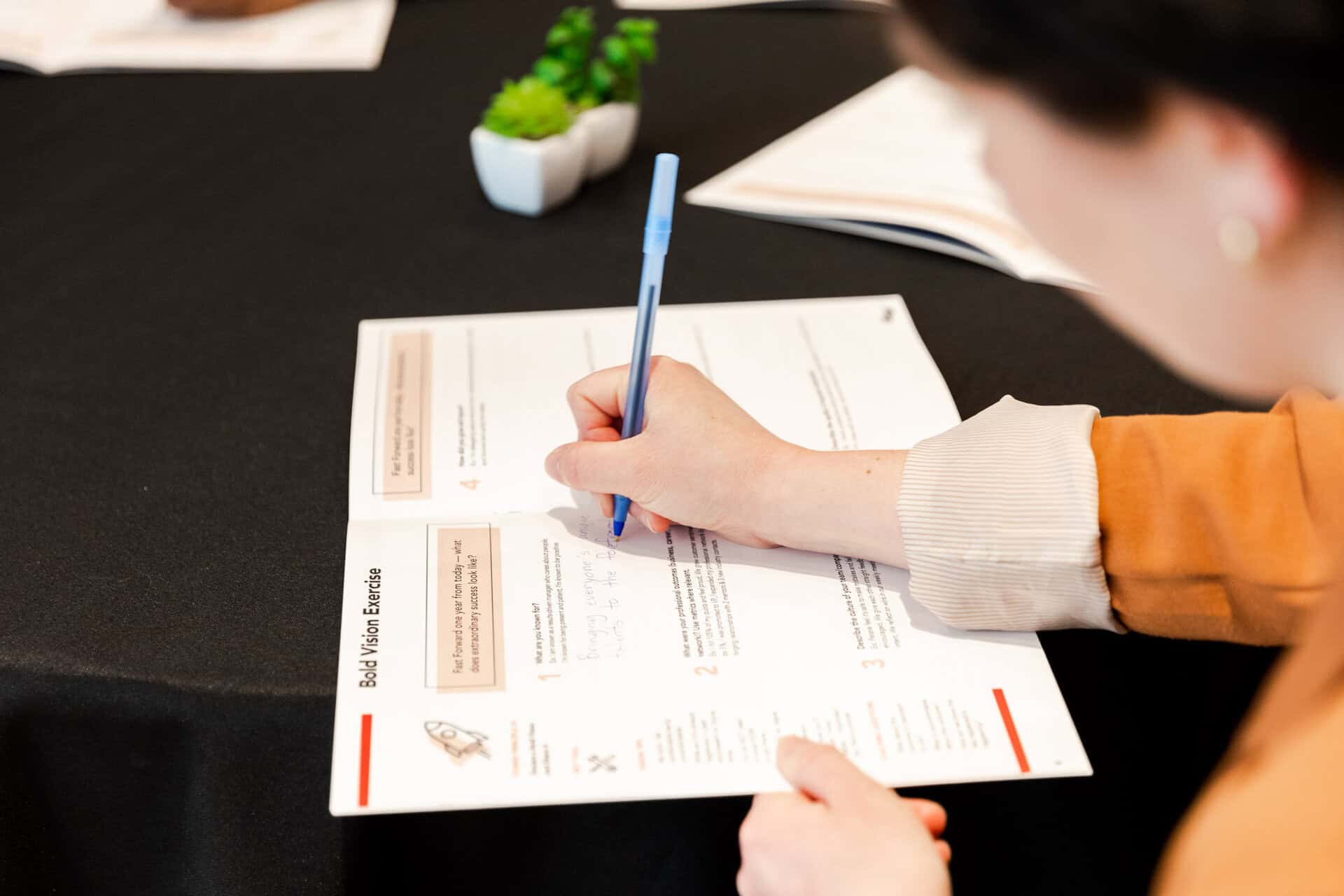 Woman taking notes for corporate training programs