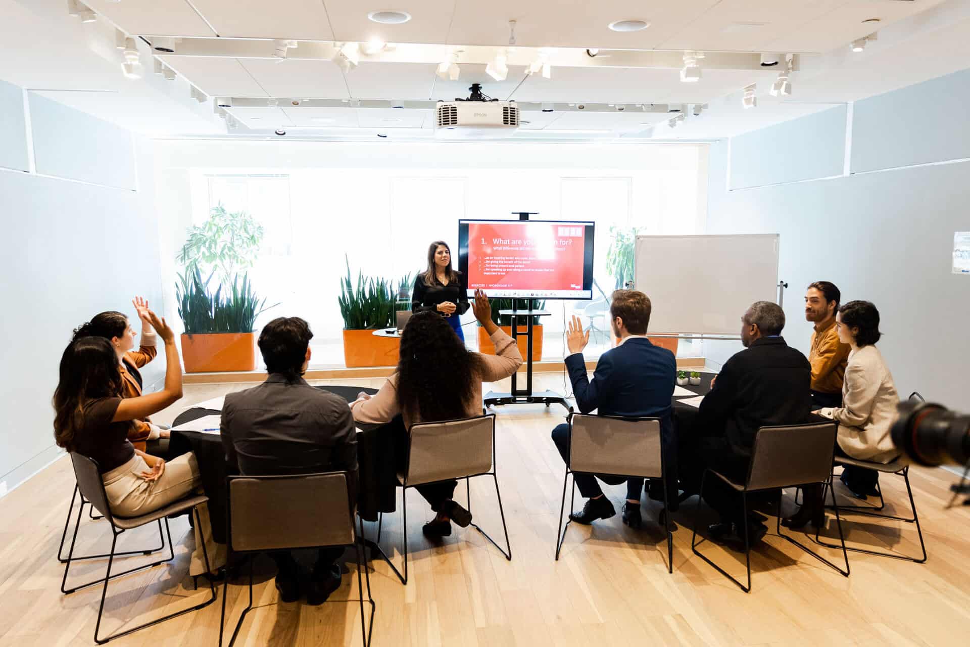 Woman leading a large group of people during leadership assessments