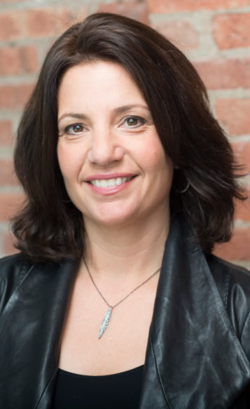Portrait of a smiling brunette woman working for a professional leadership program