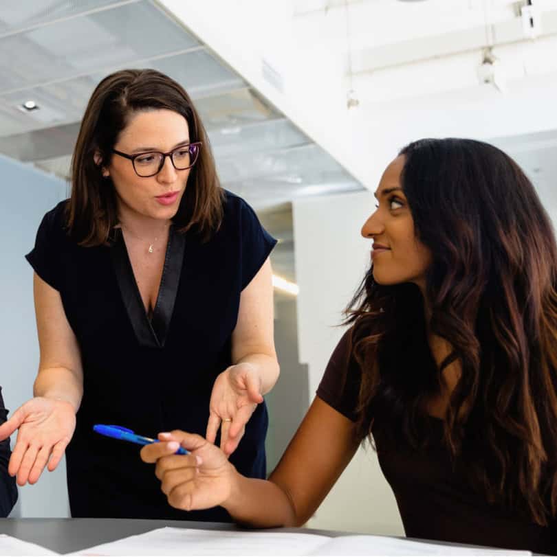 Two woman working on a development training program in an office