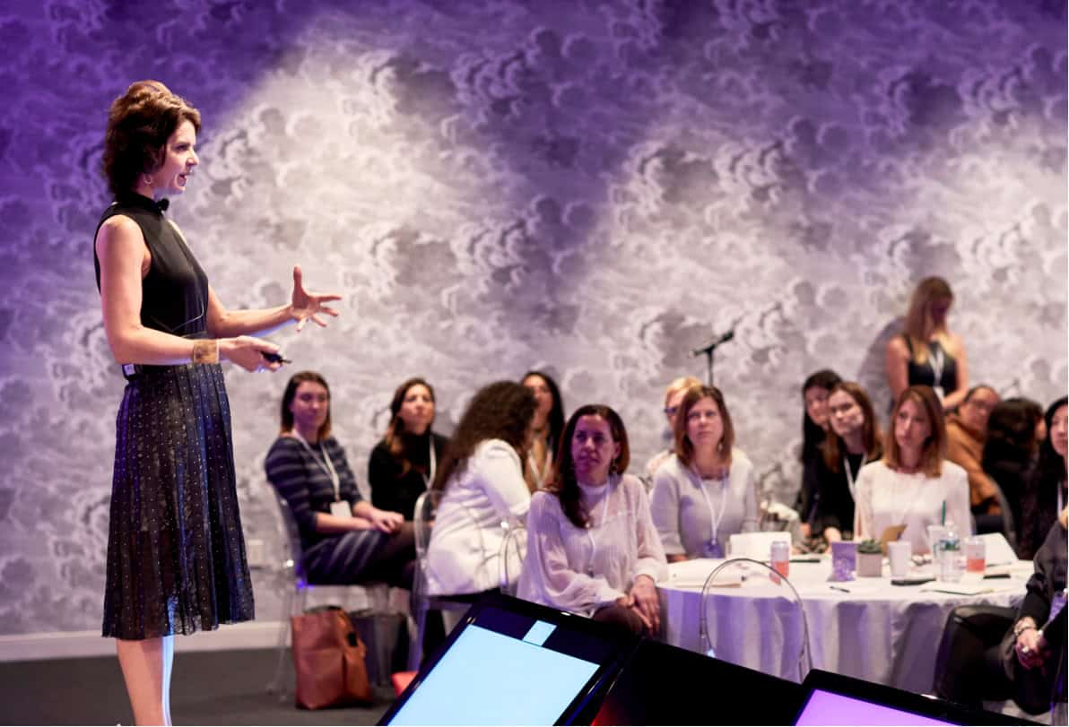 Woman leading a workshop on stage for employee engagement statistics