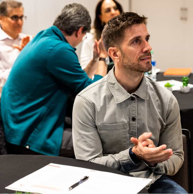 Young white man clapping during professional development programs