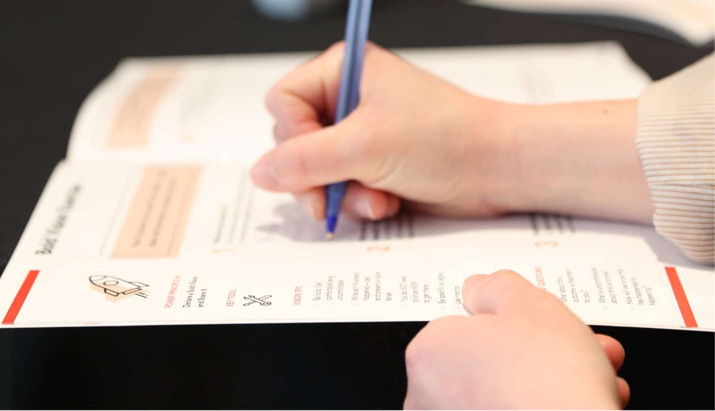 Fast forward attendee looking at materials