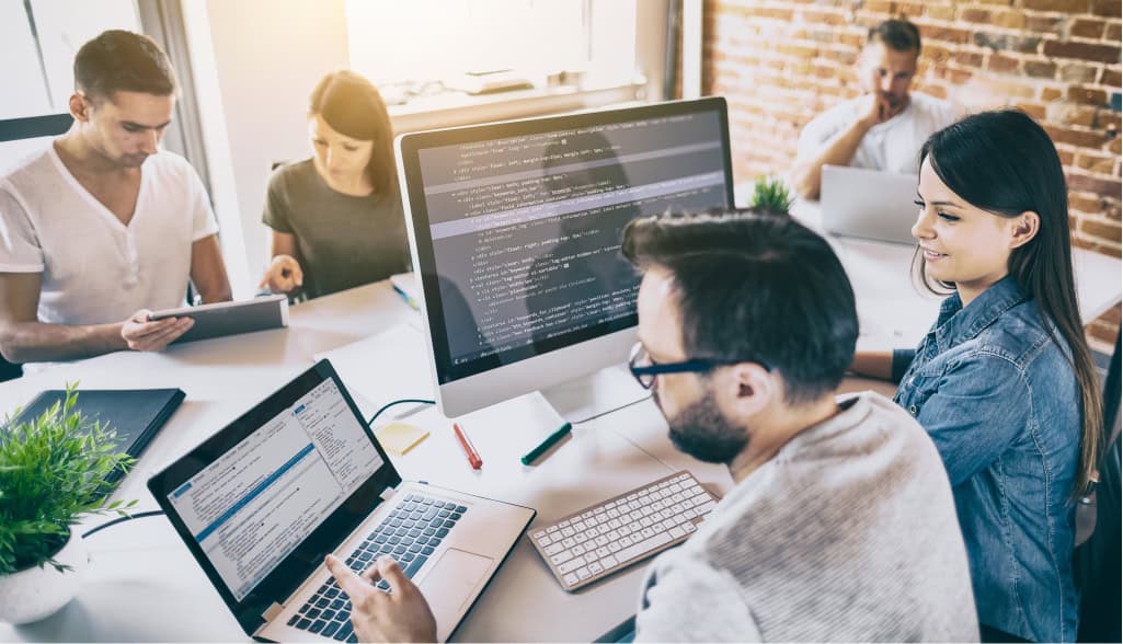 Group of workers using computers for technology talent development