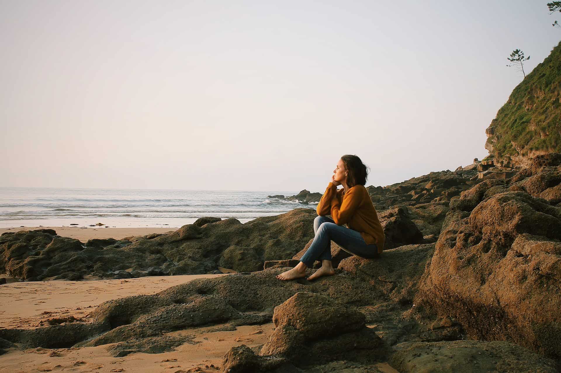women thinking on beach