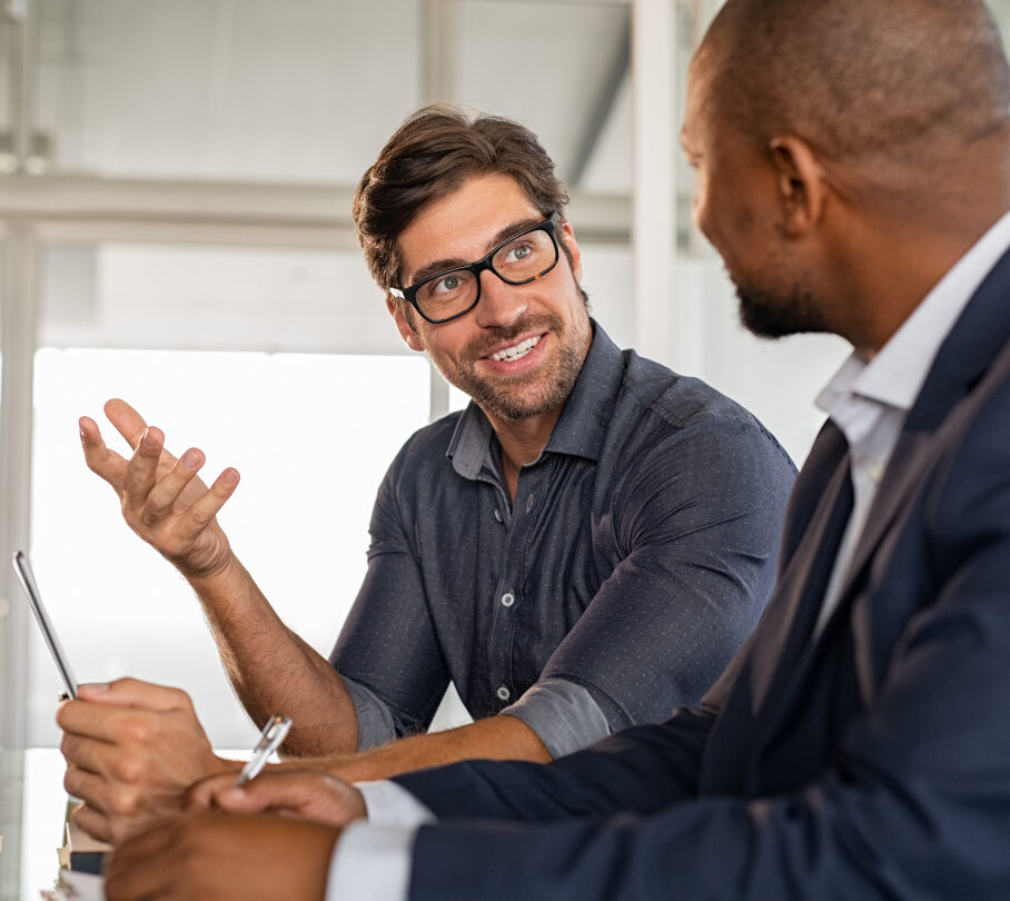 2 Professional young men discussing corporate training programs with coffees