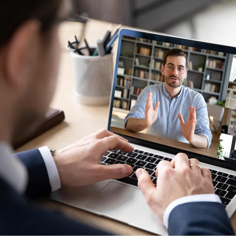 Professional man watching a video about leadership assessments on laptop