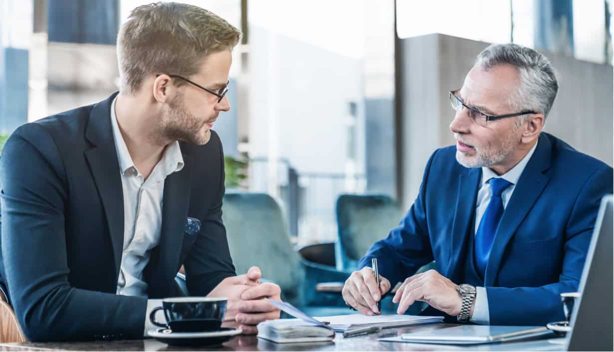two men talking at an office