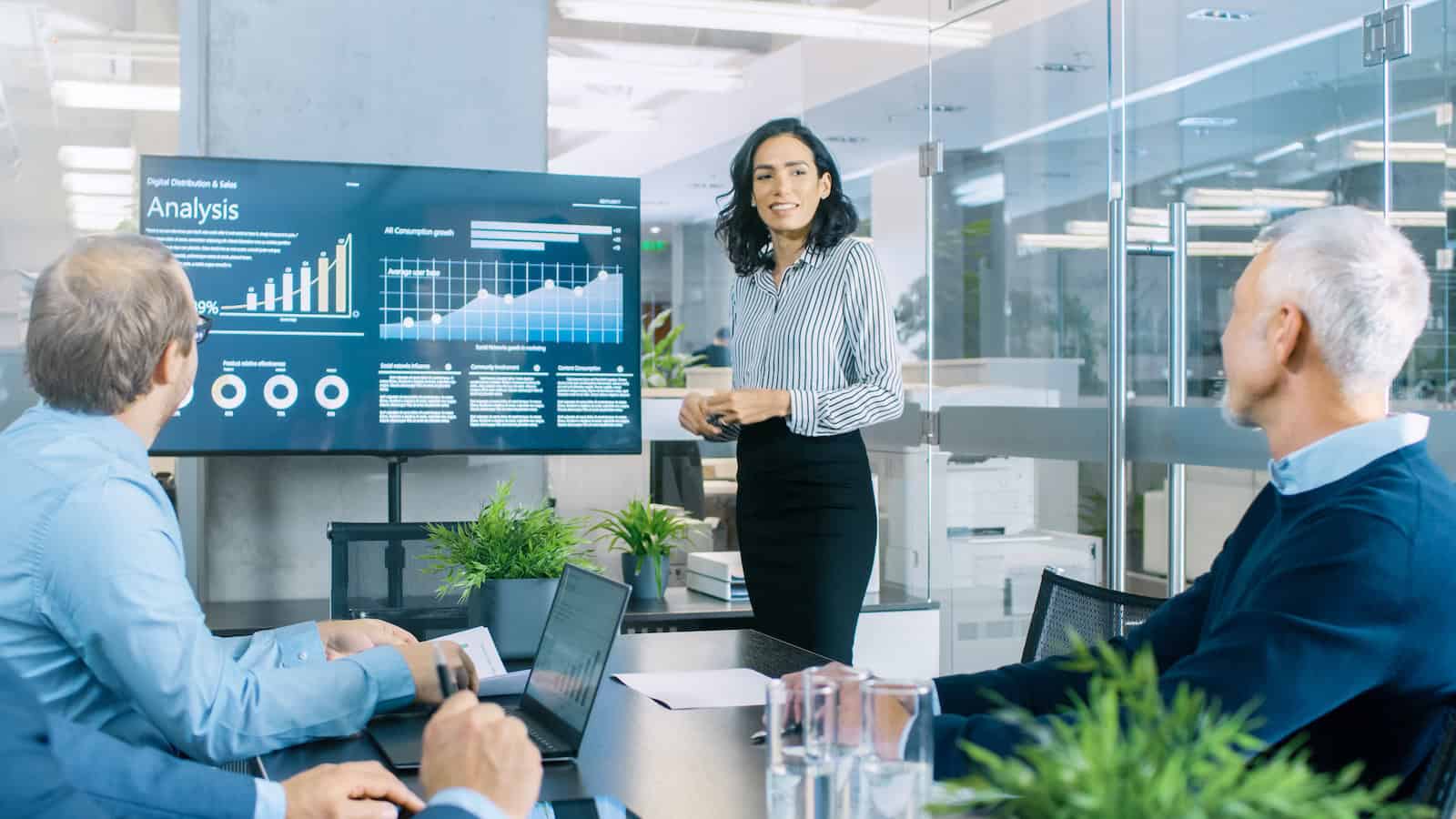 Young woman presenting statistics in an office about professional development for sales