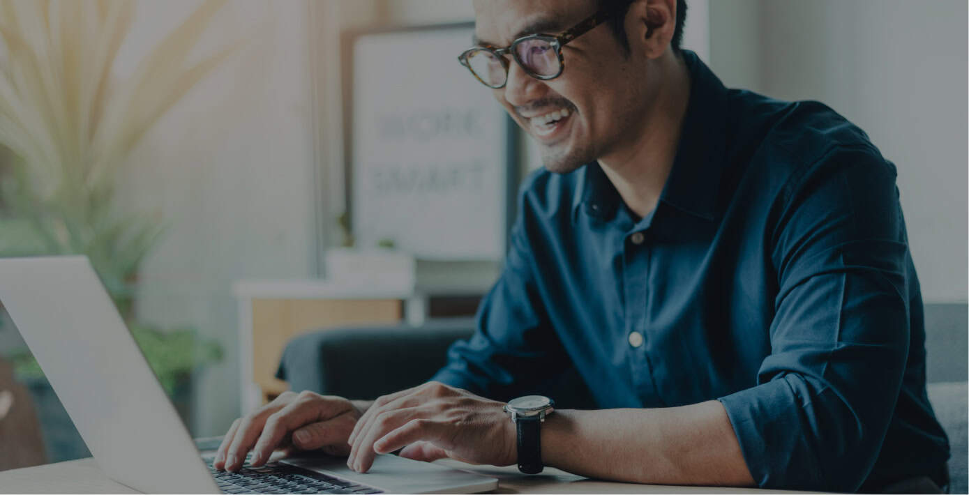 Young man with glasses working on professional development for engineers on a laptop