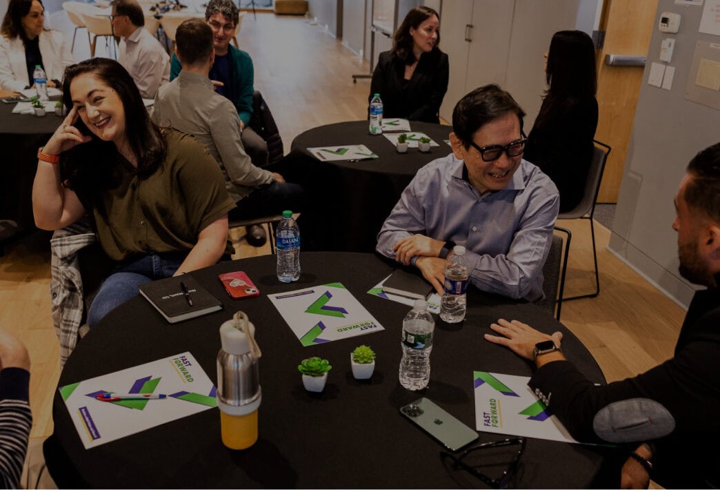 Diverse coworkers happily discussing workplace diversity training