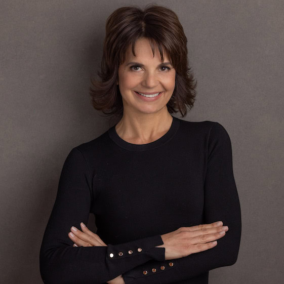 Fast Forward CEO and co-author Lisa McCarthy smiles with her arms crossed